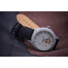 Load image into Gallery viewer, The Luminor Series was conceived with the idea of bold illumination of the digits and hands on a minimalistic watch face. Our first model in this series is featuring a matt grey casing, exquisite black genuine leather strap, bold luminous green digits and hands and a matt grey finish on the dial. We manufacture this watch under the control and supervision of our experienced and skilled watchmakers in our own workshop.