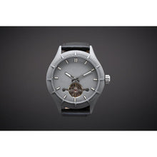 Load image into Gallery viewer, The Luminor Series was conceived with the idea of bold illumination of the digits and hands on a minimalistic watch face. Our first model in this series is featuring a matt grey casing, exquisite black genuine leather strap, bold luminous green digits and hands and a matt grey finish on the dial. We manufacture this watch under the control and supervision of our experienced and skilled watchmakers in our own workshop.