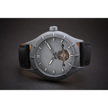 Load image into Gallery viewer, The Luminor Series was conceived with the idea of bold illumination of the digits and hands on a minimalistic watch face. Our first model in this series is featuring a matt grey casing, exquisite black genuine leather strap, bold luminous green digits and hands and a matt grey finish on the dial. We manufacture this watch under the control and supervision of our experienced and skilled watchmakers in our own workshop.