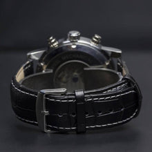 Load image into Gallery viewer, The Nebulae series features a flying Tourbillon on the left side of the face and a multifaceted dial synchronized for pure metallic perfection that leaves a mark with a great statement. Additional features include month, day of week, day/night, 12/24 hour, day of the month, hours, minutes, seconds. The movement of the watch is visible through its transparent back. Masculine, sophisticated and elegant.