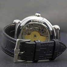 Load image into Gallery viewer, Masterpiece Minuit, an enchanting interpretation of time brought to its pure skeleton essence. Aesthetically perfected with inventive and meticulous architecture with a flying Tourbillon, encased with high quality 316L stainless steel casing and powered by a 21 jewel automatic movement with a 60-hour power reserve and a moon phase.