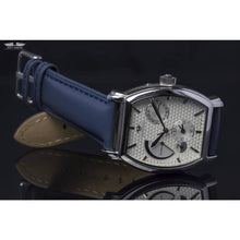 Load image into Gallery viewer, Le Cadre is a venture into fine craftsmanship and an elevation of contemporary design. Exuding an air of fine taste and class with a flawless aesthetic face, the silver coated stainless steel rectangular structure embodies sheer exclusivity. Features include a flying Tourbillon within our signature Matt Arend skeleton calibre, 21 jewel automatic movement with a 60-hour power reserve, day/night, date, hour, minute, second, dual time zone and power reserve of moment indicator functions.