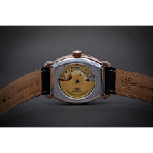 Load image into Gallery viewer, Le Cadre is a venture into fine craftsmanship and an elevation of contemporary design. Exuding an air of fine taste and class with a flawless aesthetic face, the rose-gold coated stainless steel rectangular structure embodies sheer exclusivity. Features include a flying Tourbillon within our signature Matt Arend skeleton calibre, 21 jewel automatic movement with a 60-hour power reserve, day/night, date, hour, minute, second, dual time zone and power reserve of moment indicator functions.