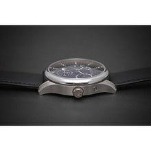 Load image into Gallery viewer, L'Atelier Dual Time is a venture into fine craftsmanship and an elevation of contemporary design. Exuding an air of fine taste and class with a flawless aesthetic face, the satin brushed stainless steel casing embodies modern exclusivity. Features include a Date, Day/Night Indicator, Second Time Zone and a Power Reserve Display showing you exactly the percentage remaining on the self winding 21 jewel automatic calibre.