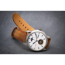Load image into Gallery viewer, Tour De Bleu salutes traditional craftsmanship and supreme elegance with all the ingredients for a true watch collector in a modern legacy timepiece. Distinctly confident and classic with exclusive features including moon phase, minute, hour, second indicators, open heart calibre providing a 60-hour power reserve for precision and focus it is a true statement piece, blending into the lifestyles of the modern gentleman through its clean and gorgeous light brown suede strap and the well balanced dial layout a