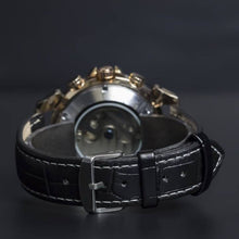 Load image into Gallery viewer, Andaluz is a powerful yet elegant expression of the male fascination with mechanical watch making. Features include day and month calendar, hours, minutes, seconds. The movement of the watch is visible through its transparent back. Extrovert, confident and elegant.