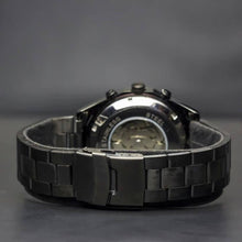 Load image into Gallery viewer, A brand new edition in our Elements series comes with darker features for the modern gentleman. Equipped with black coated stainless steel case and strap and a black metallic face to give this timepiece its solid masculine character. Features include hour, minute, second, date and month indicators and an automatic mechanical chronometer with a 48-hour power reserve.
