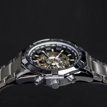 Load image into Gallery viewer, Elements with its raw metallic skeleton design is a magnetic timepiece for the modern gentleman. Equipped with stainless steel case and strap and a black and silver metallic face to give this timepiece its solid masculine character. Features include hour, minute, second, date and month indicators and an automatic mechanical chronometer with a 48-hour power reserve. 
