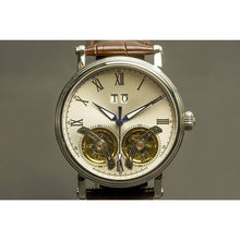 Load image into Gallery viewer, The Heritage timepiece is a grand manifest in the refinement and aesthetics. With inventive and meticulous architecture of its dual balance wheel, a sleek profile of the hands, timekeeping is optimized to the highest amplitude. Encased with a refined silver titanium dial and a high quality 316L stainless steel casing lie the the two hearts of this exclusive timepiece that is powered by a 26 jewel automatic movement with a 60-hour power reserve. Made for the dedicated watch lover with a genuine taste for fin
