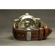 Load image into Gallery viewer, The Heritage timepiece is a grand manifest in the refinement and aesthetics. With inventive and meticulous architecture of its dual balance wheel, a sleek profile of the hands, timekeeping is optimized to the highest amplitude. Encased with a refined silver titanium dial and a high quality 316L stainless steel casing lie the the two hearts of this exclusive timepiece that is powered by a 26 jewel automatic movement with a 60-hour power reserve. Made for the dedicated watch lover with a genuine taste for fin
