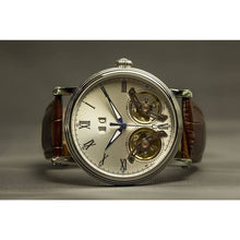 Load image into Gallery viewer, The Heritage timepiece is a grand manifest in the refinement and aesthetics. With inventive and meticulous architecture of its dual balance wheel, a sleek profile of the hands, timekeeping is optimized to the highest amplitude. Encased with a refined silver titanium dial and a high quality 316L stainless steel casing lie the the two hearts of this exclusive timepiece that is powered by a 26 jewel automatic movement with a 60-hour power reserve. Made for the dedicated watch lover with a genuine taste for fin
