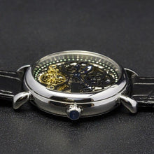 Load image into Gallery viewer, Masterpiece Minuit, an enchanting interpretation of time brought to its pure skeleton essence. Aesthetically perfected with inventive and meticulous architecture with a flying Tourbillon, encased with high quality 316L stainless steel casing and powered by a 21 jewel automatic movement with a 60-hour power reserve and a moon phase.
