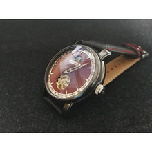 Load image into Gallery viewer, This Piece features a single hand functioning as the Hour Hand and a reworked dial splitting the Hours into 15 Minute Segments on the outer ring. No Minute or Second Hand are needed in this configuration. The Watch has a Day/Night Phase and an open Heart Automatic Movement with a 60 Hour Power Reserve.
