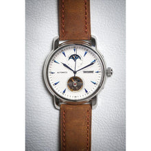 Load image into Gallery viewer, Tour De Bleu salutes traditional craftsmanship and supreme elegance with all the ingredients for a true watch collector in a modern legacy timepiece. Distinctly confident and classic with exclusive features including moon phase, minute, hour, second indicators, open heart calibre providing a 60-hour power reserve for precision and focus it is a true statement piece, blending into the lifestyles of the modern gentleman through its clean and gorgeous light brown suede strap and the well balanced dial layout a
